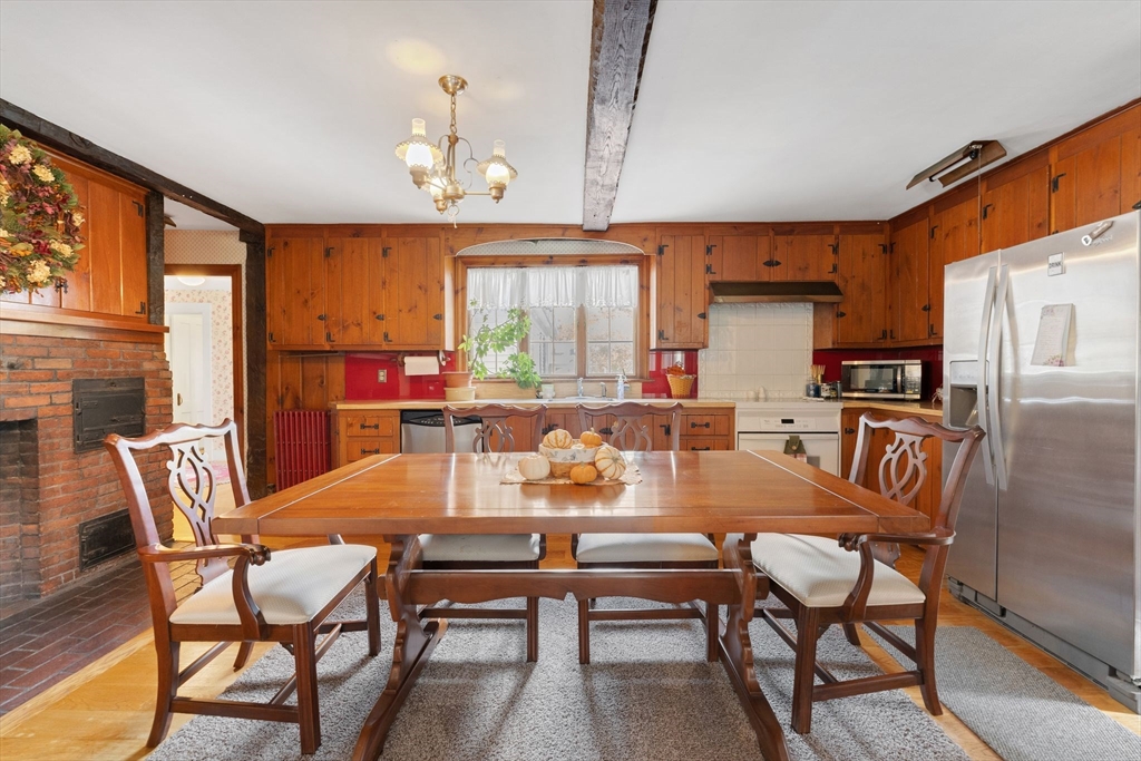 114 Summer Street Maynard, MA 01754 - Photo 5 of 32 a dining room with a table chairs and a kitchen view