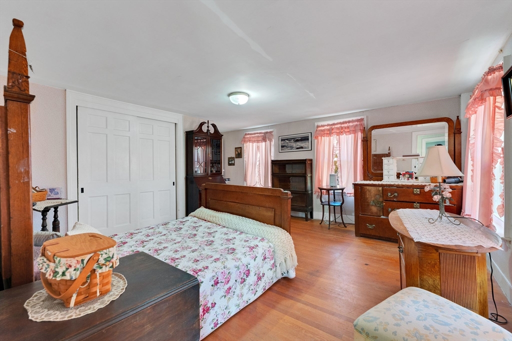 114 Summer Street Maynard, MA 01754 - Photo 8 of 32 a bedroom with a bed and wooden floor