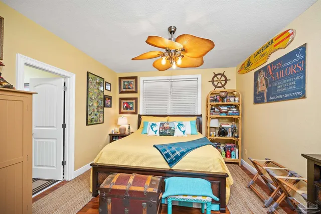 a bedroom with a bed and a painting on the wall