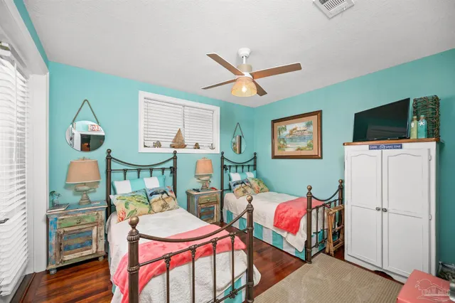 a living room with furniture a flat screen tv and couches