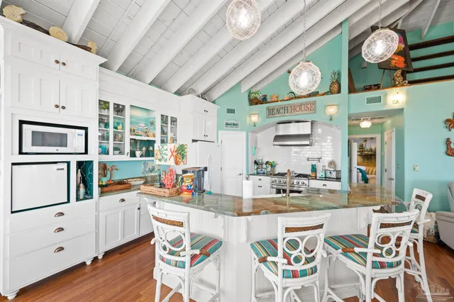 an open kitchen with stainless steel appliances granite countertop a stove and cabinets
