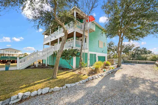 a view of a house with a yard and sitting area