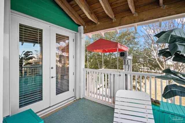 a view of a balcony with furniture and floor to ceiling window