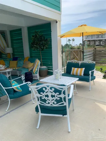 a balcony with furniture and a potted plant