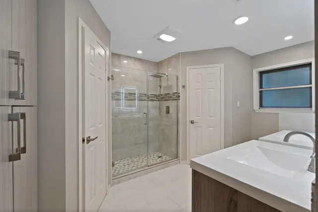 a bathroom with double sink and a mirror