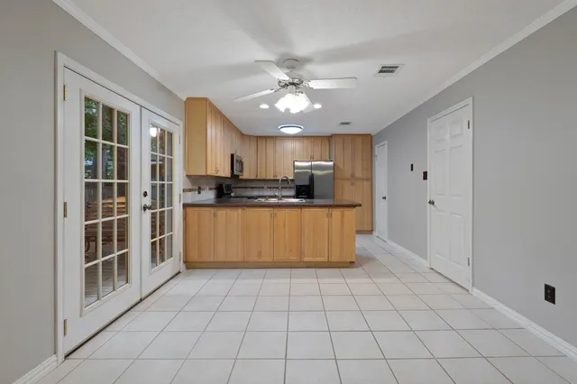a kitchen with refrigerator and cabinets