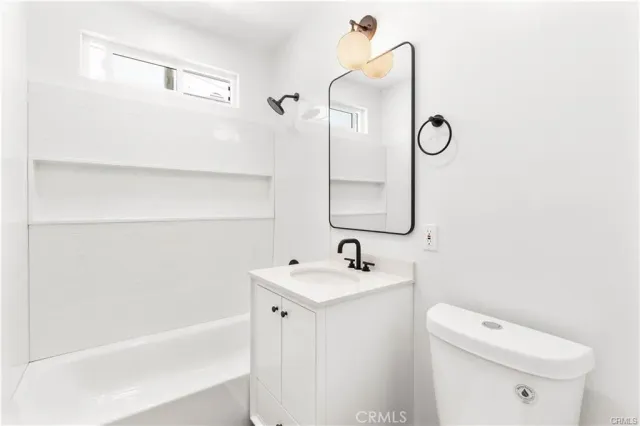 a bathroom with a sink a toilet and a bathtub