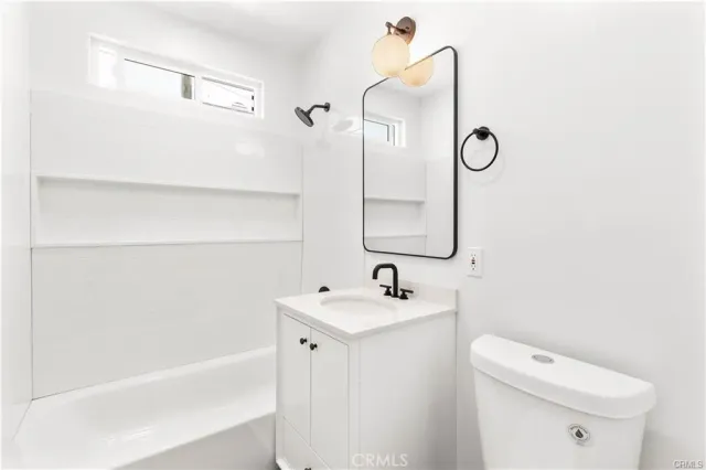 a bathroom with a sink a toilet and a bathtub