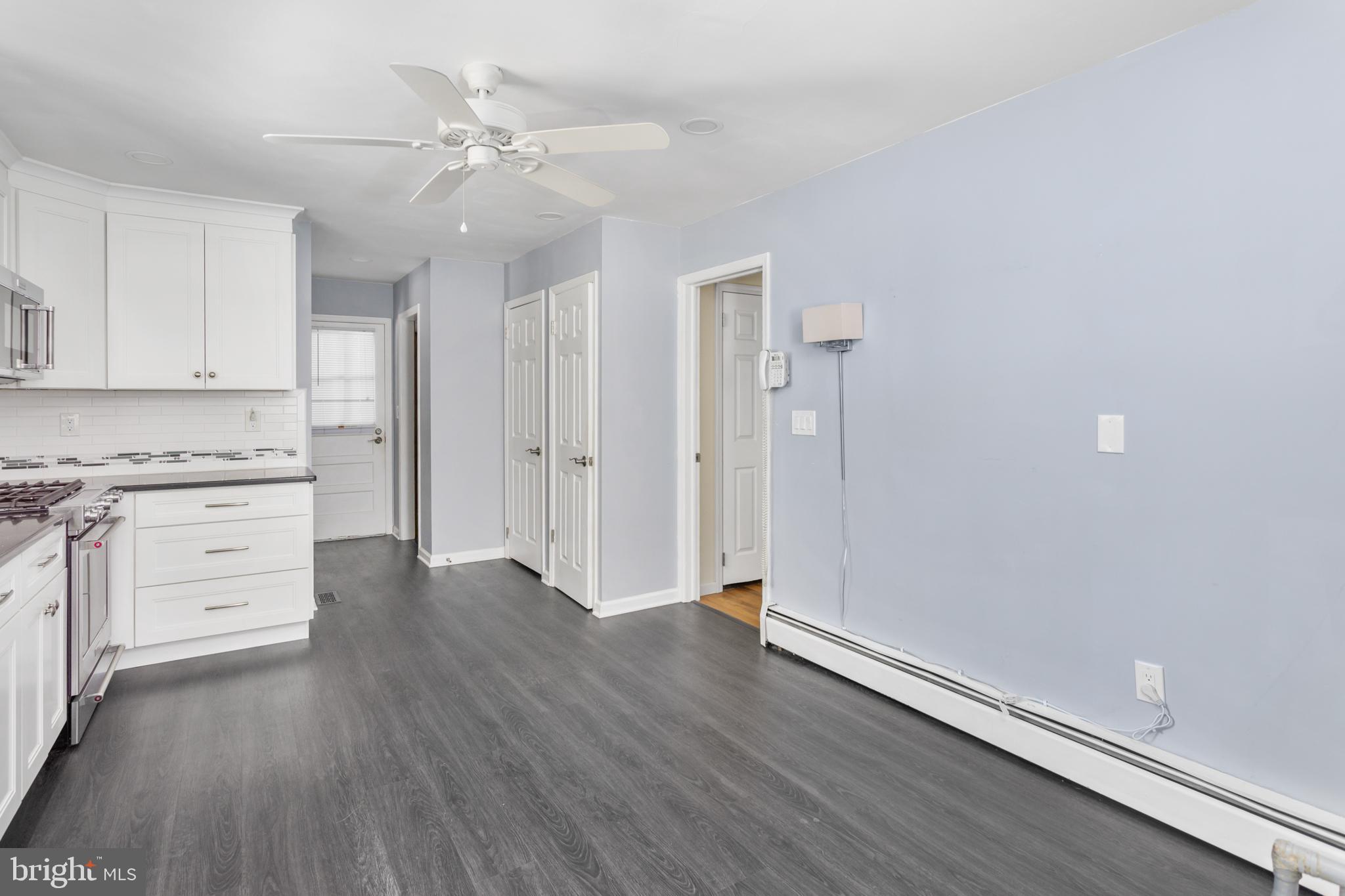 11 Mountain Vw Road Ewing, NJ 08628 - Photo 18 of 36 an empty room with cabinet wooden floors and kitchen view