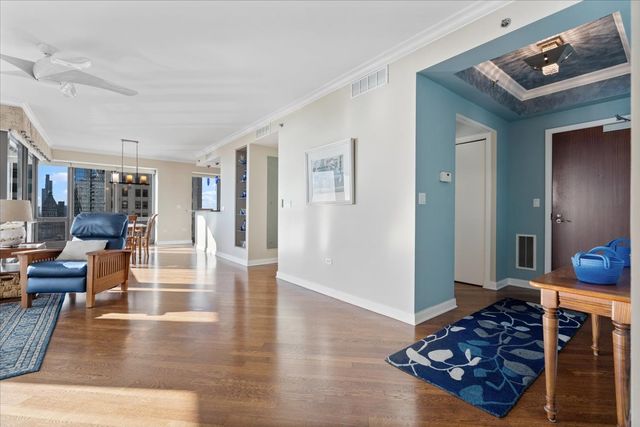 a living room with furniture and a wooden floor