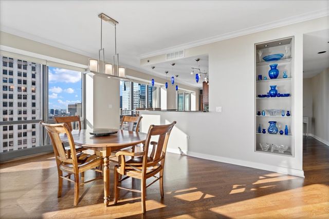 a kitchen with stainless steel appliances granite countertop sink stove refrigerator and cabinets