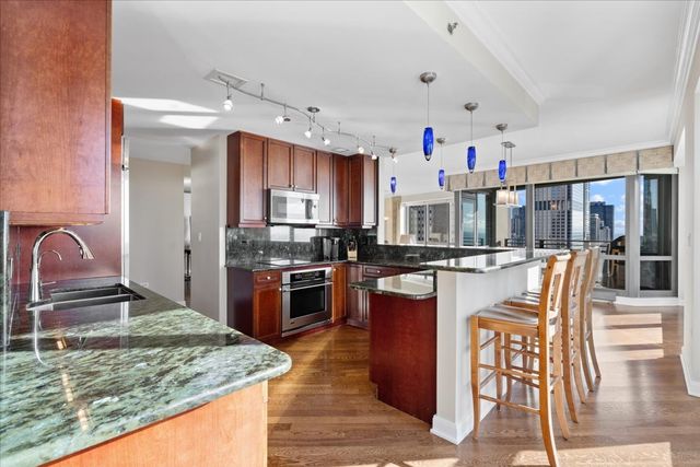 a kitchen with granite countertop a sink and cabinets