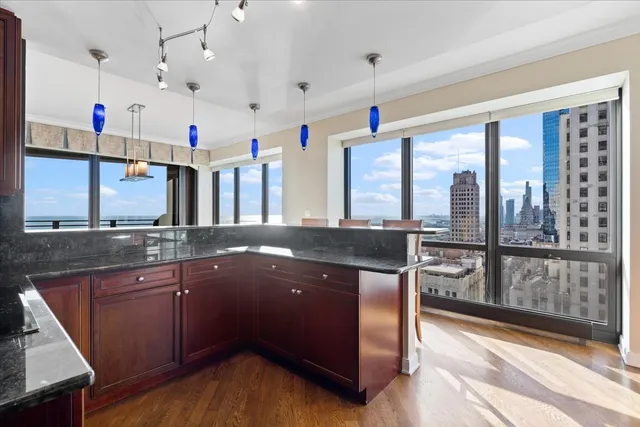 a kitchen with granite countertop wooden cabinets and stainless steel appliances