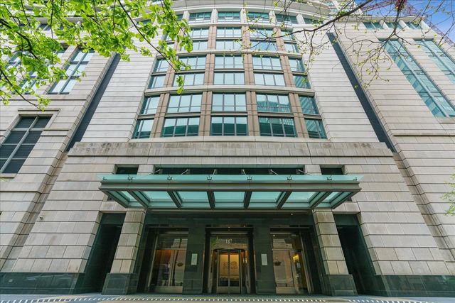 a front view of a building with a garden