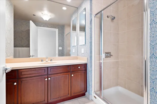 a bed sitting in a spacious bedroom next to a window