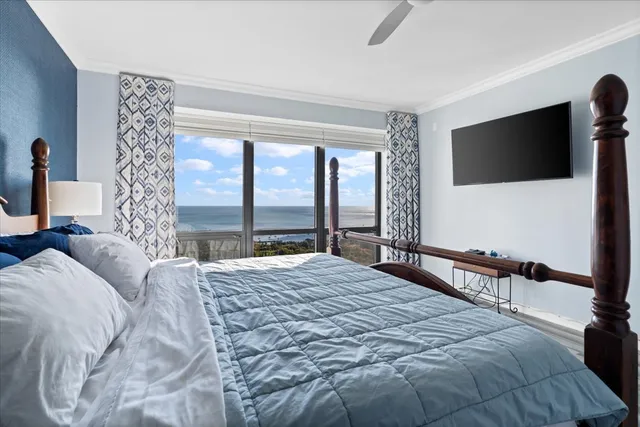 a bedroom with a bed and a chandelier