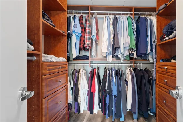 a bedroom with a large bed and a chandelier