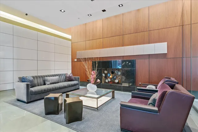 a living room with furniture a rug and a large window