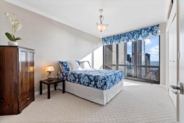 a bedroom with a large bed and a large window