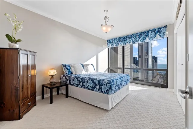 a bedroom with a large bed and a large window