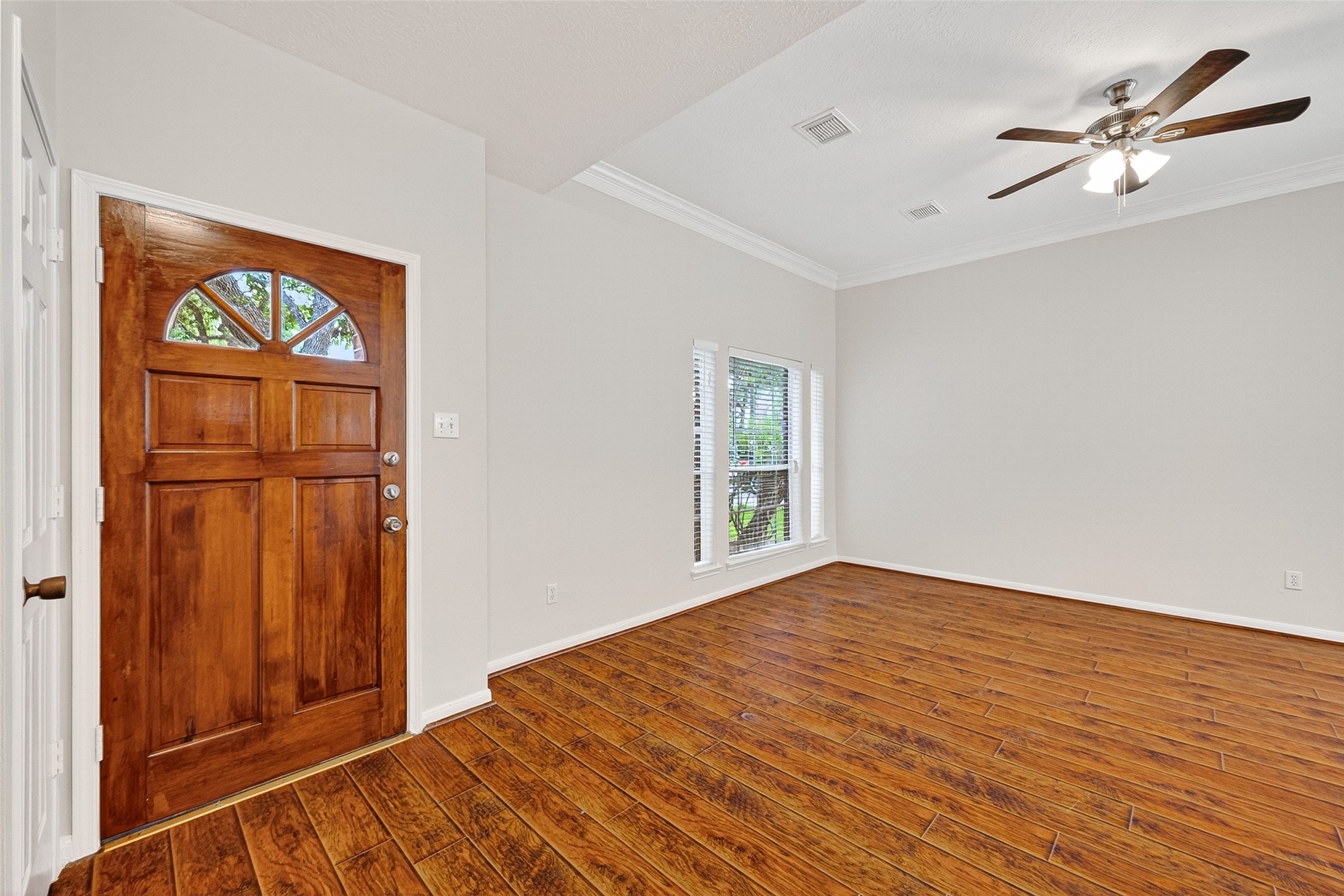 4539 Springfield Lakes Street Sugar Land, TX 77479 - Photo 2 of 34 a view of an empty room with a window and wooden floor