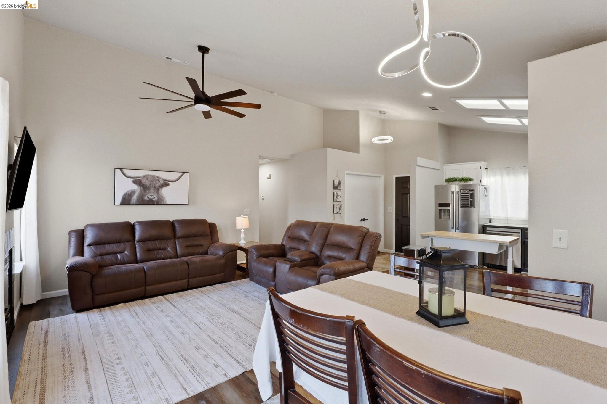 799 Morgans Ranch Circle Galt, CA 95632 - Photo 9 of 36 Living room featuring vaulted ceiling, wood finished floors, and ceiling fan