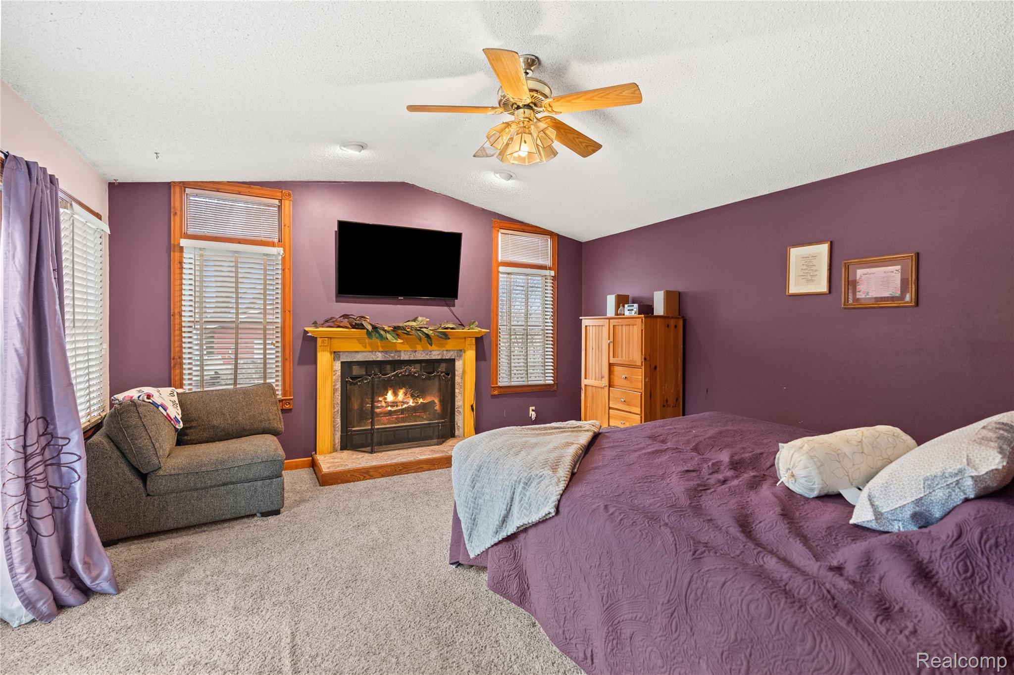 6076 East Carpenter Road Flint, MI 48506 - Photo 21 of 67 Carpeted bedroom featuring a high end fireplace and a ceiling fan