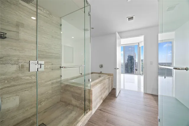 a bathroom with a double vanity sink mirror and shower