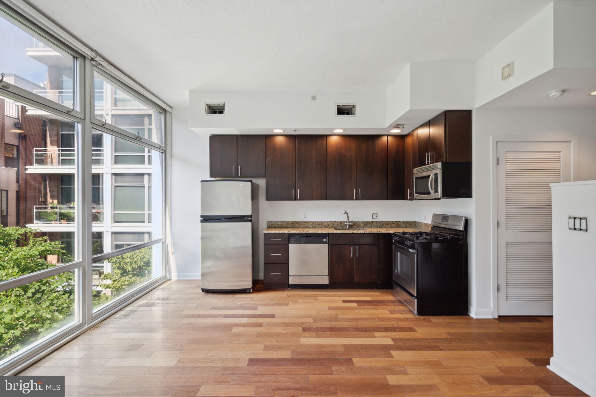 22 South Front Street, Unit 304 Philadelphia, PA 19106 - Photo 3 of 20 a large kitchen with stainless steel appliances and large cabinets