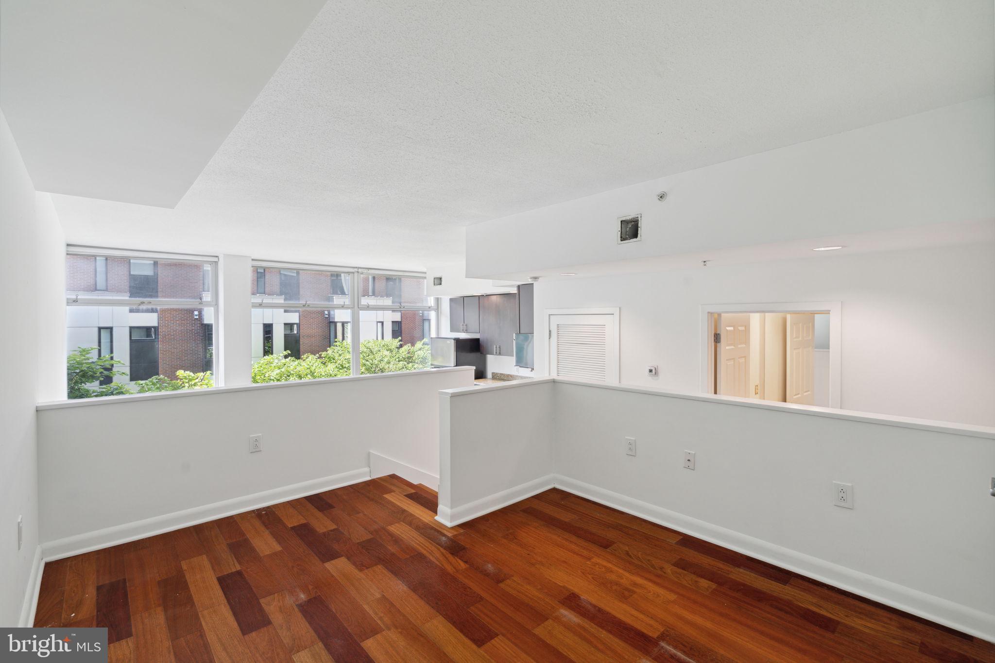 22 South Front Street, Unit 304 Philadelphia, PA 19106 - Photo 8 of 20 a view of kitchen with wooden floor and electronic appliances