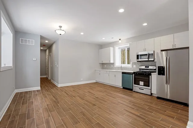 a view of kitchen electric appliances and cabinets