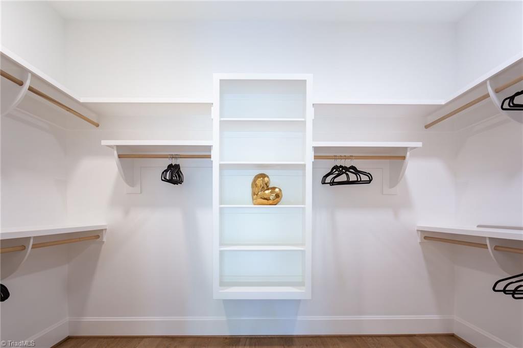 2512 Rivers Edge Road Summerfield, NC 27358 - Photo 22 of 33 Primary closet with builtins and custom shelving.
