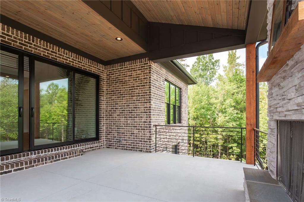 2512 Rivers Edge Road Summerfield, NC 27358 - Photo 28 of 33 Covered Rear Porch with gas fireplace
