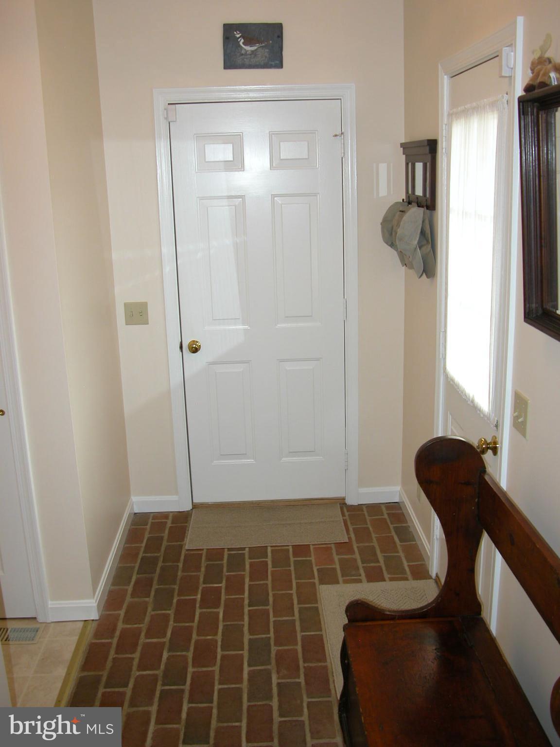 8111 Church Neck Road St. Michaels, MD 21663 - Photo 21 of 30 Utility room hall to garage: Brick floor