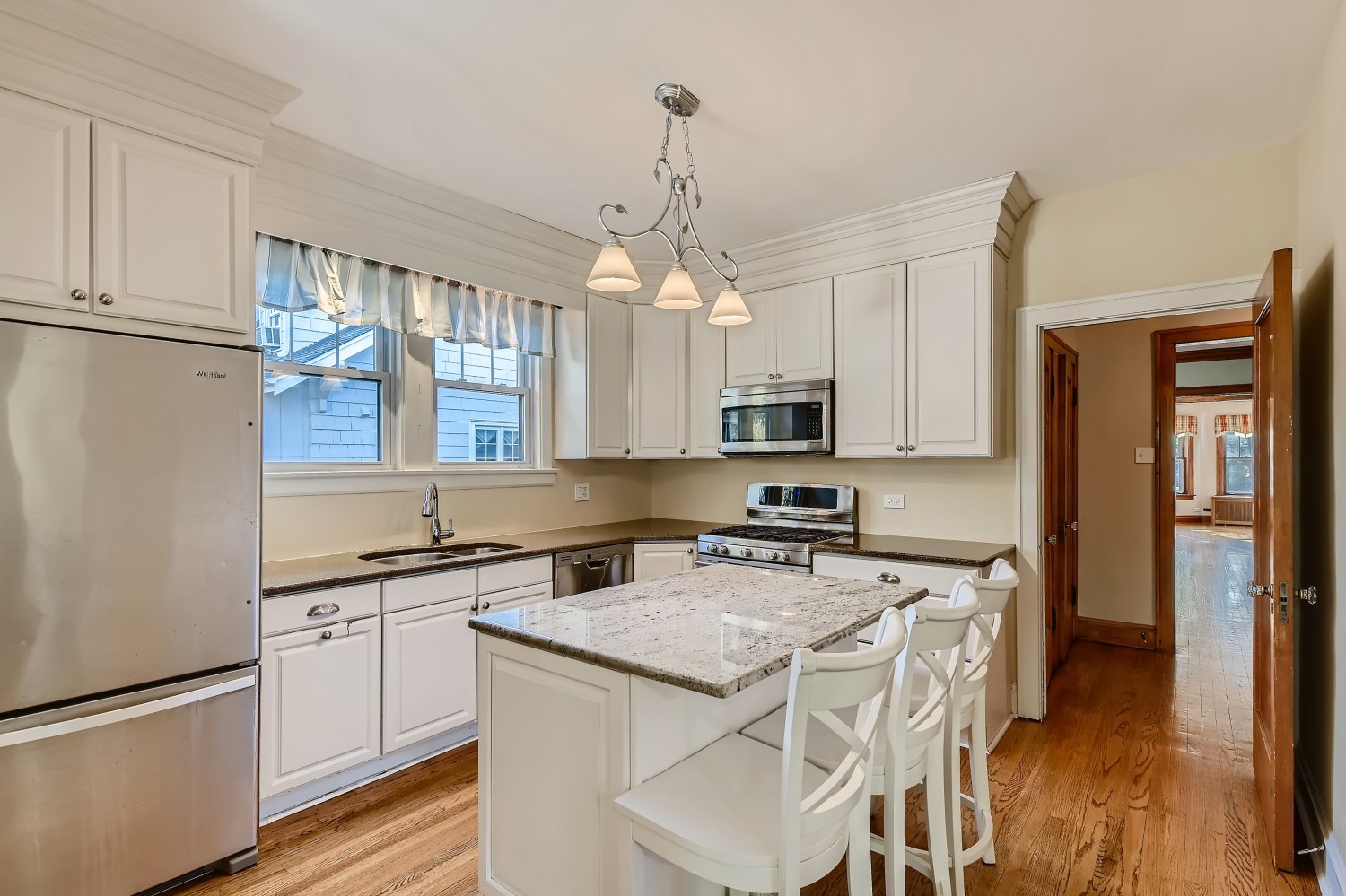 341 Nuttall Road Riverside, IL 60546 - Photo 6 of 28 a kitchen with stainless steel appliances granite countertop a stove top oven a sink a refrigerator and white cabinets