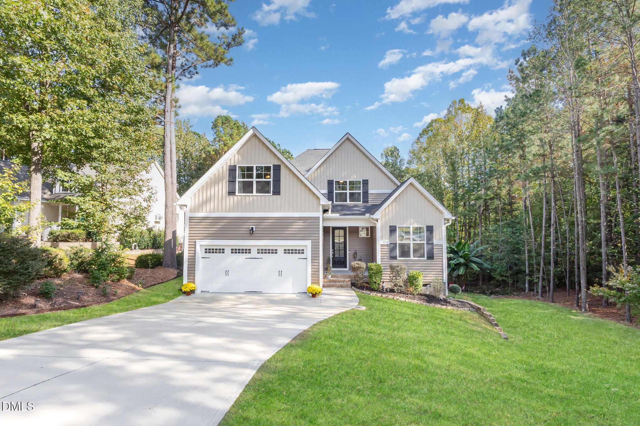 128 Waterleaf Place Clayton, NC 27527 - Photo 1 of 57 a front view of a house with a garden and trees