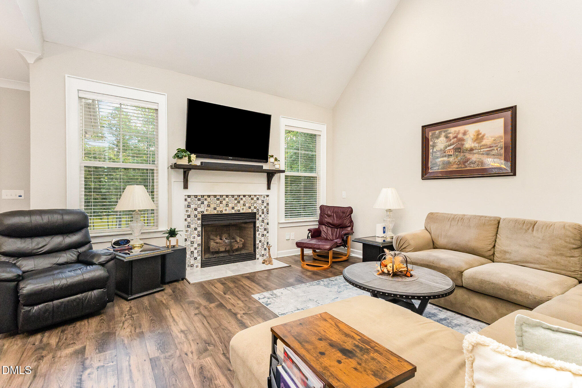 128 Waterleaf Place Clayton, NC 27527 - Photo 19 of 57 a living room with furniture a flat screen tv and a fireplace