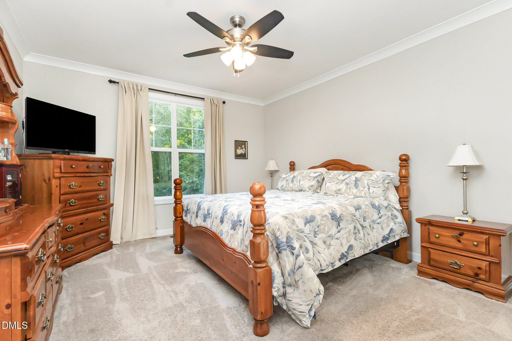 128 Waterleaf Place Clayton, NC 27527 - Photo 21 of 57 a bedroom with a bed and a flat screen tv