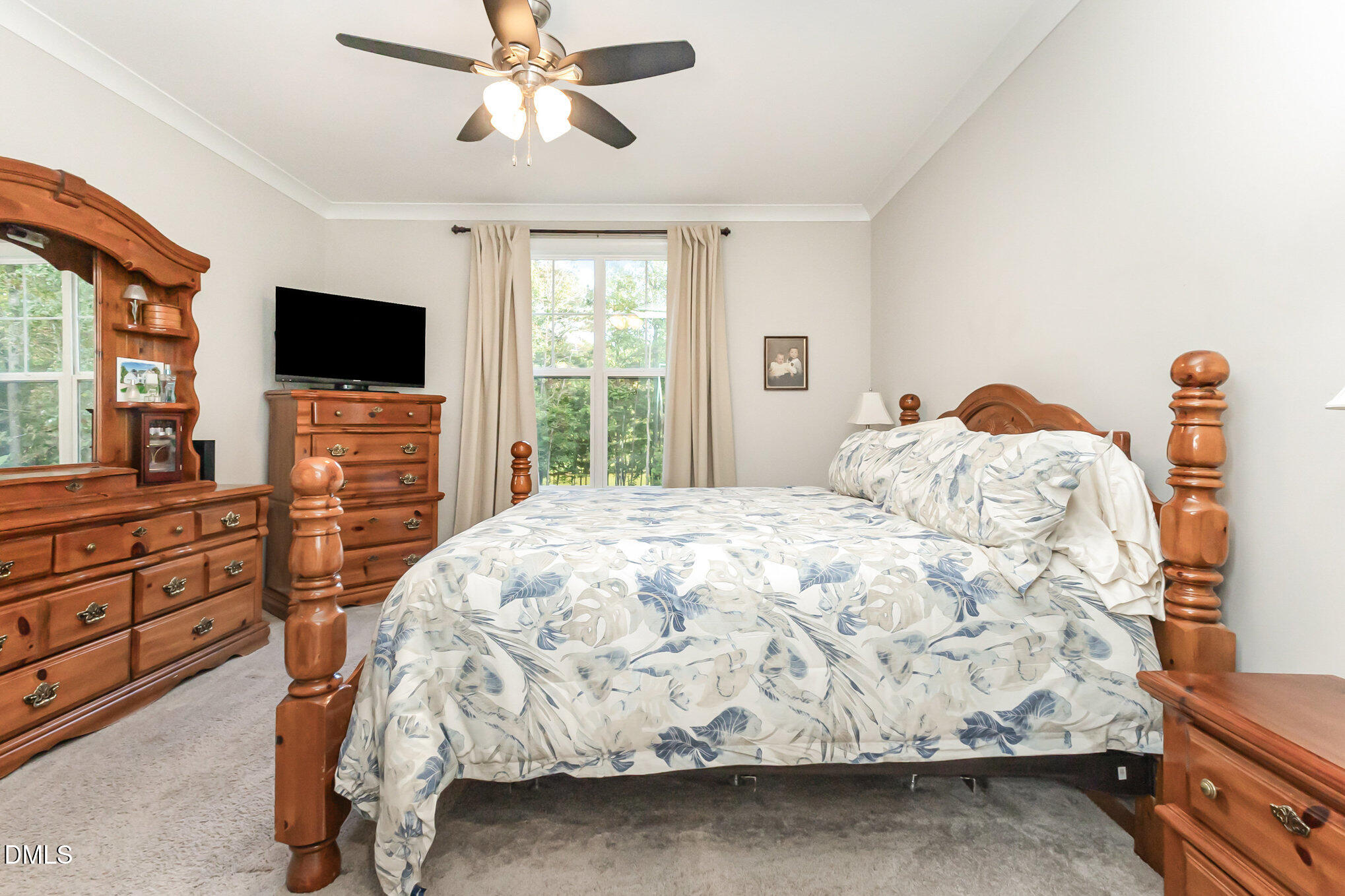 128 Waterleaf Place Clayton, NC 27527 - Photo 22 of 57 a bedroom with a bed and a flat screen tv
