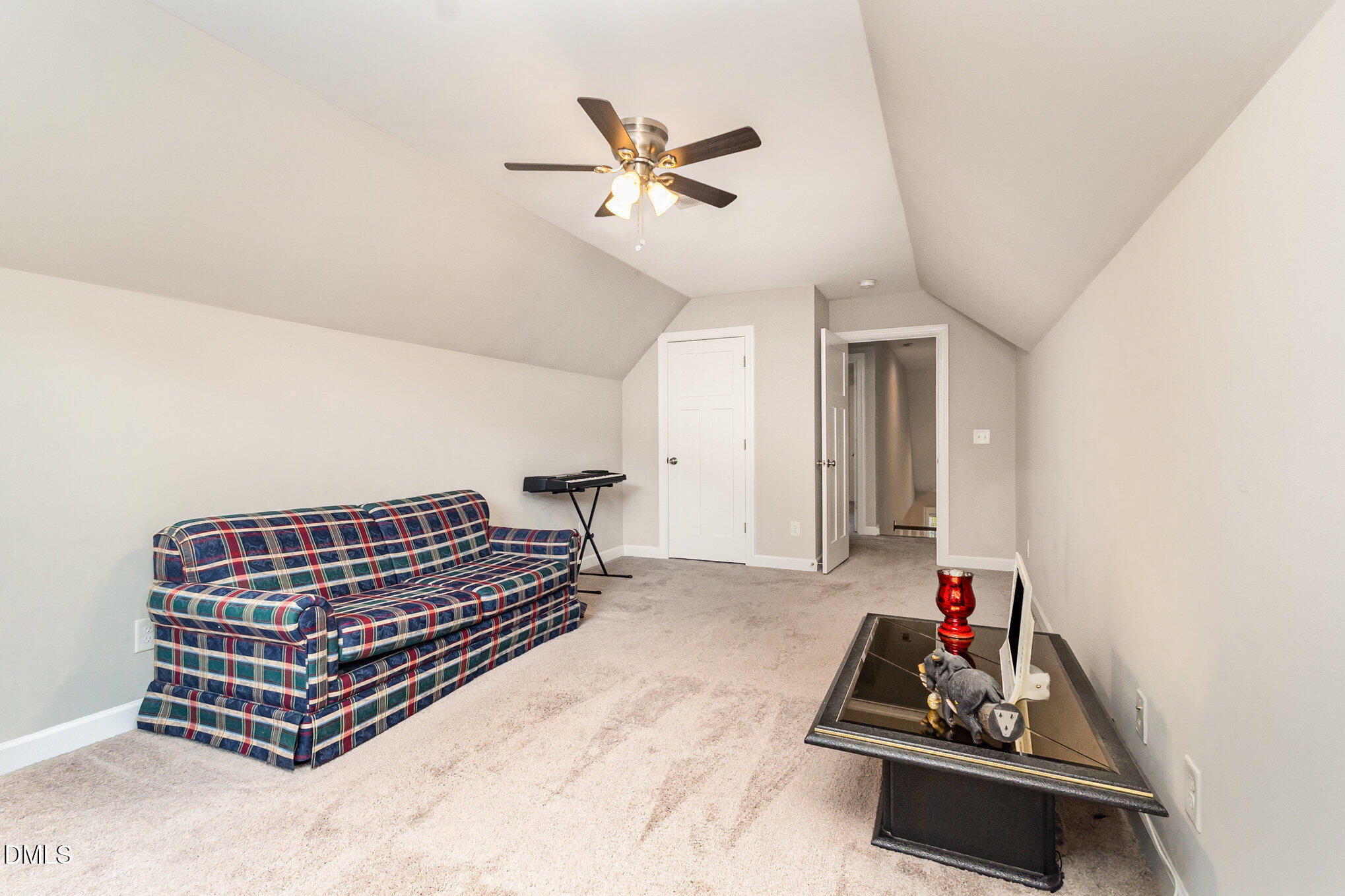 128 Waterleaf Place Clayton, NC 27527 - Photo 30 of 57 a living room with furniture a ceiling fan and a rug