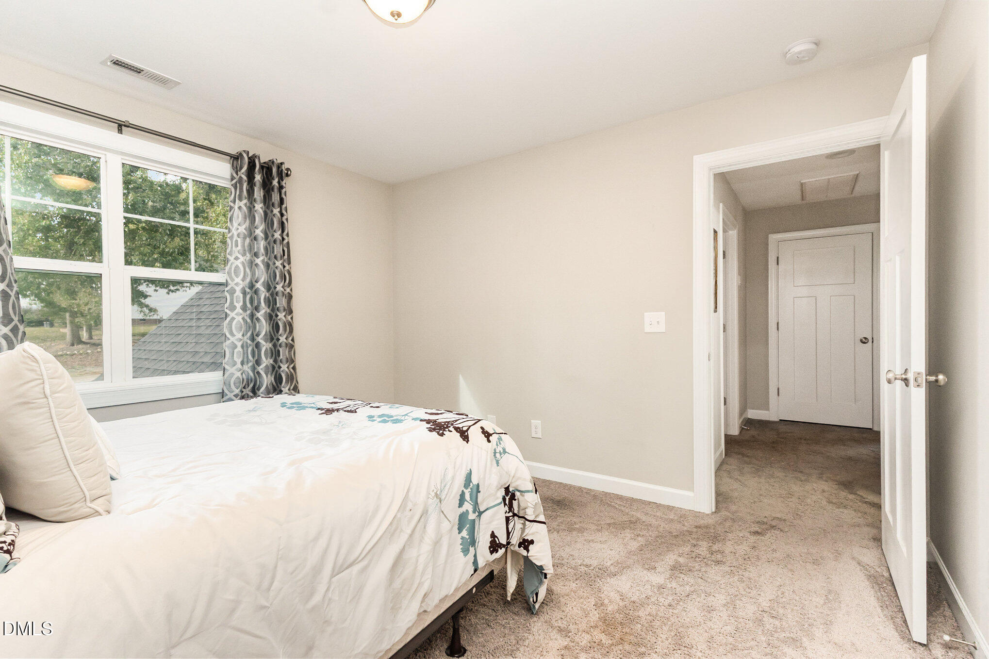 128 Waterleaf Place Clayton, NC 27527 - Photo 32 of 57 a bedroom with a bed and a window