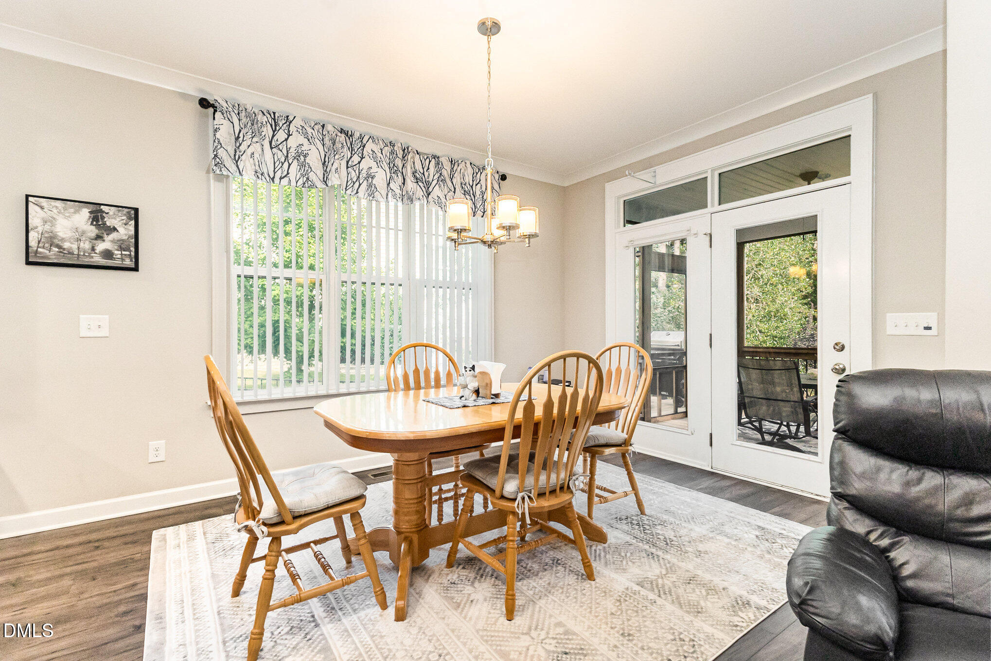 128 Waterleaf Place Clayton, NC 27527 - Photo 35 of 57 a dining room with furniture a chandelier and wooden floor