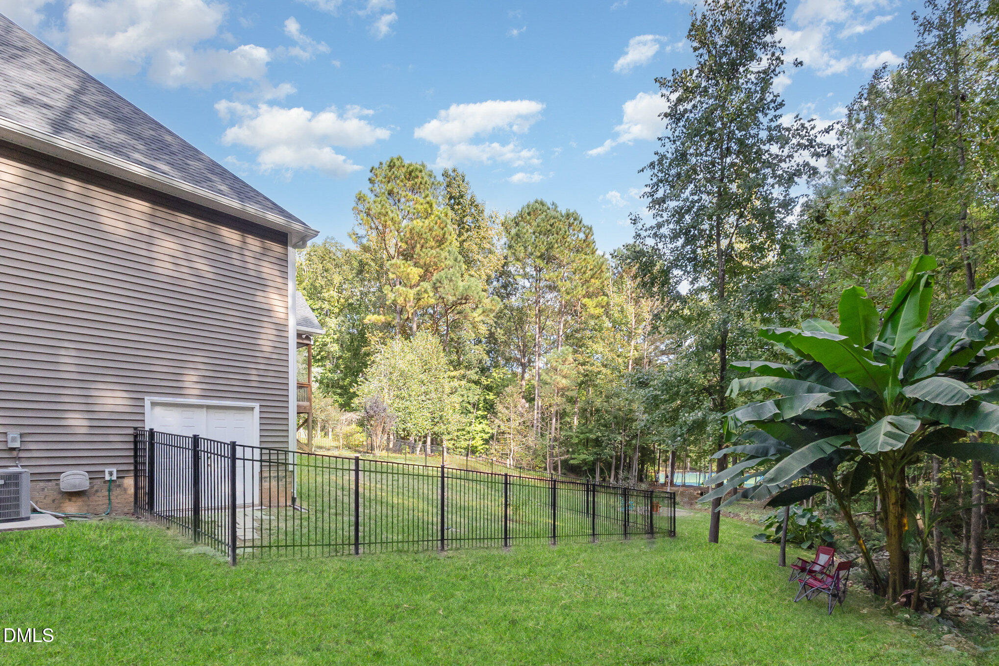 128 Waterleaf Place Clayton, NC 27527 - Photo 41 of 57 a view of a backyard with plants and large trees