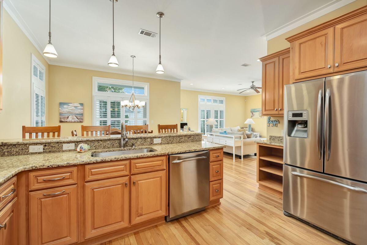 20 Sawgrass Lane Santa Rosa Beach, FL 32459 - Photo 7 of 25 a kitchen with stainless steel appliances granite countertop a refrigerator a sink dishwasher a stove and white countertops with wooden floor