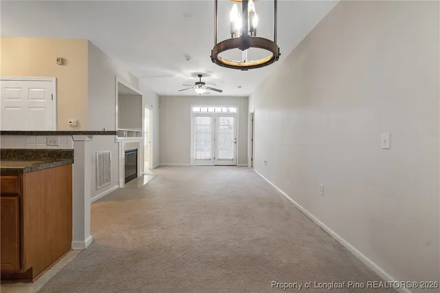 a kitchen with stainless steel appliances granite countertop a refrigerator and a stove