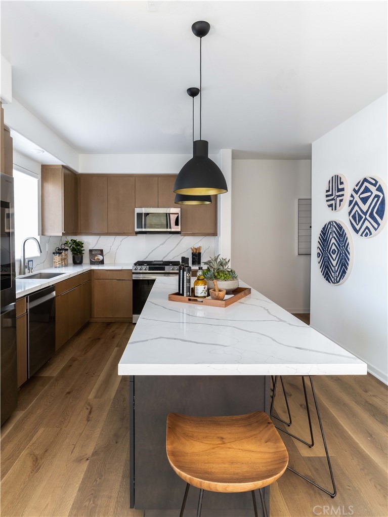 1479 Azalea Circle Gardena, CA 90247 - Photo 14 of 33 a kitchen with sink a stove and chairs