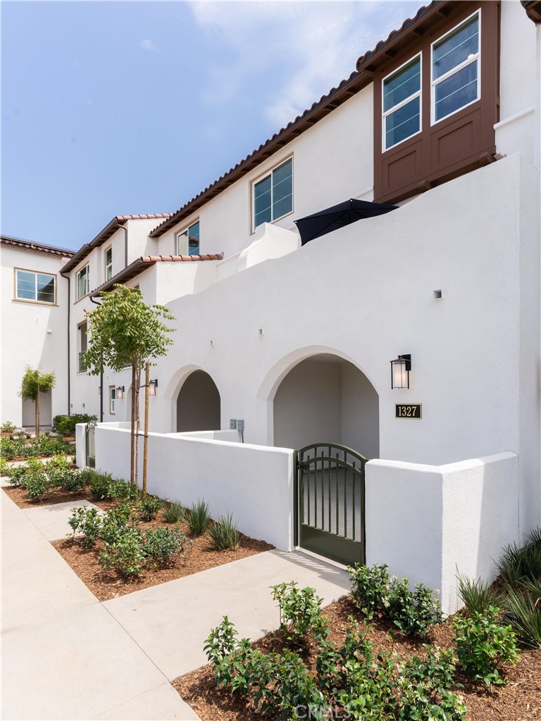 1479 Azalea Circle Gardena, CA 90247 - Photo 3 of 33 a front view of a house with plants and entryway