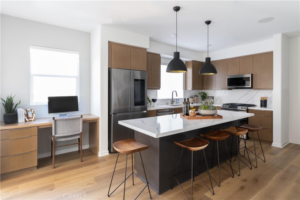 1479 Azalea Circle Gardena, CA 90247 - Photo 10 of 33 a kitchen with stainless steel appliances kitchen island granite countertop a sink a stove and a refrigerator