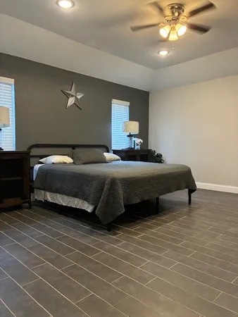 a view of empty room with wooden floor