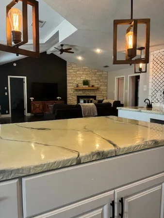 a kitchen that has a refrigerator a sink and cabinets
